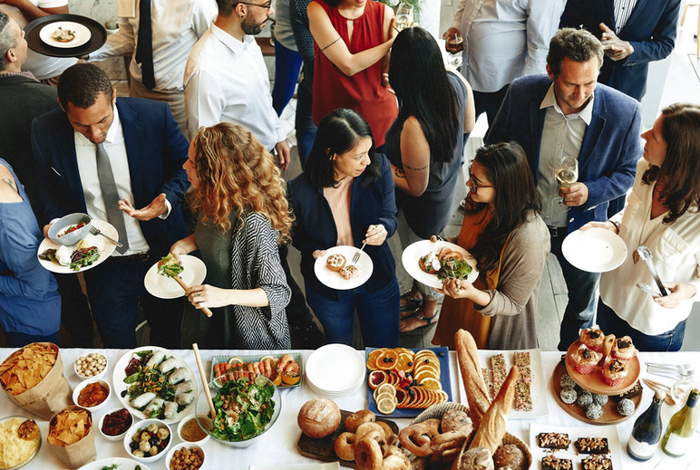 Diverse group of believers gathered for fellowship around a shared meal
